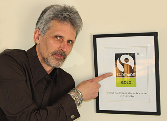 Marc Choyt, President and co-owner of Reflective Jewelry, poses with our Fairtrade Gold certification.